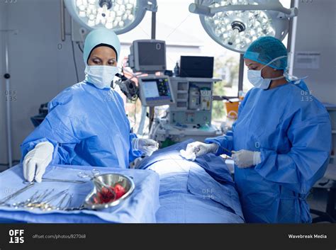 Side View Of Diverse Female Surgeons Performing Surgery In Operation