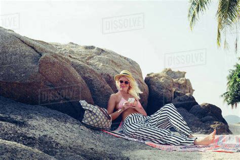 Caucasian Woman Sitting On Beach Stock Photo Dissolve