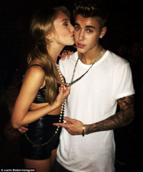 justin bieber gets a kiss from a pretty girl in a revealing leather ensemble while filming his