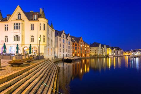 Architecture Of Alesund City Reflected In The Water At Night Norway