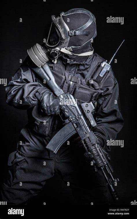 Russian Special Forces Operator In Black Uniform And Gas Mask Stock