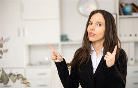 Portrait Of Woman Office Worker Pointing Finger At Empty Space Stock