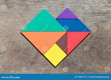 Color Tangram Puzzle In Heart Shape On Wood Background Concept For