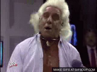 An Old Man With White Hair Wearing A Tie And Wig On The Set Of Wwe
