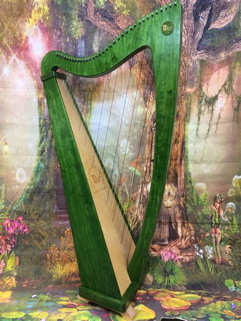 A Green Harp Sitting On Top Of A Table Next To A Wallpapered Background