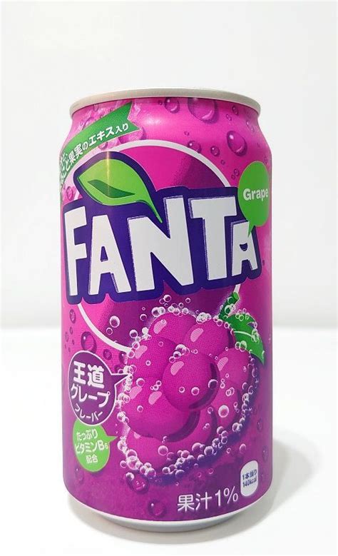 A Can Of Fanta Grape Soda With Water Droplets On The Bottom And Green