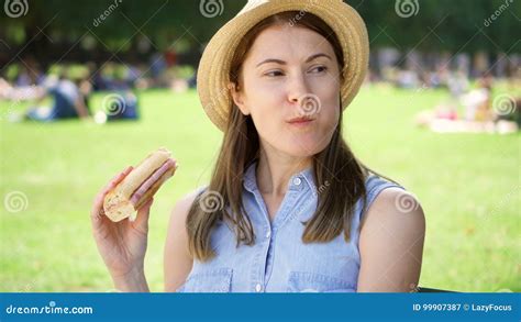Hungry Woman Eating Baguette In Park Tourist Having Lunch In Public Park Enjoying Summer Sunny