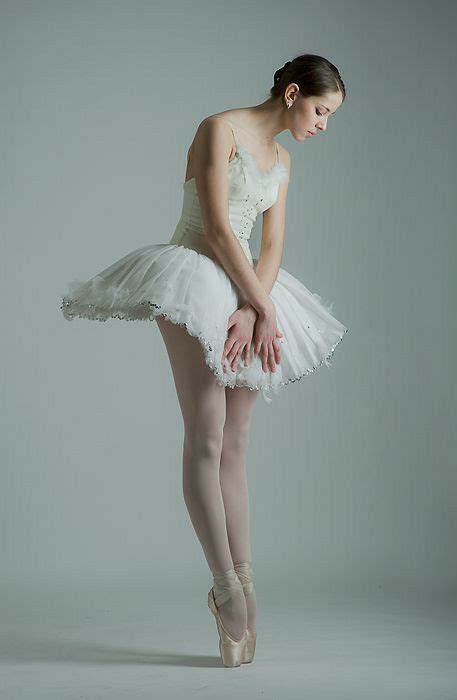 A Young Ballerina Is Posing For The Camera