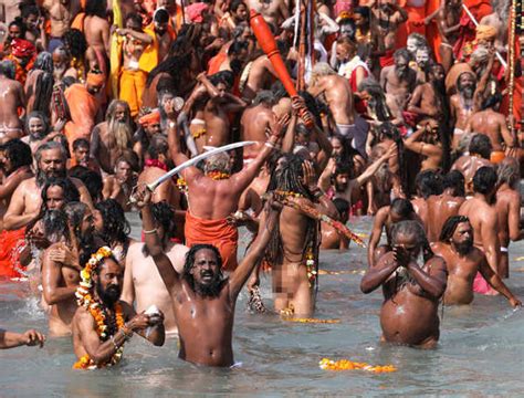 Naga Sadhus Take A Dip In The Ganges River During The First Shahi Snan At Kumbh Mela In Haridwar