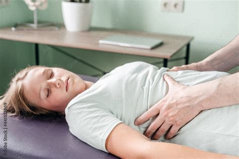 Osteopath Practitioner Releasing The Diaphragm Of A Female Patient Rib