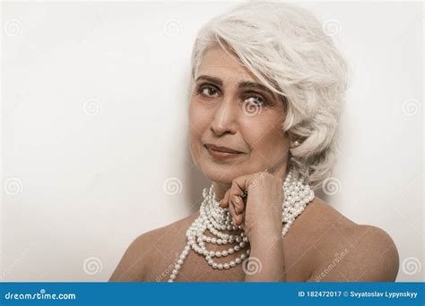 Nude Gray Haired Female Model Posing On White In Studio Stock Image