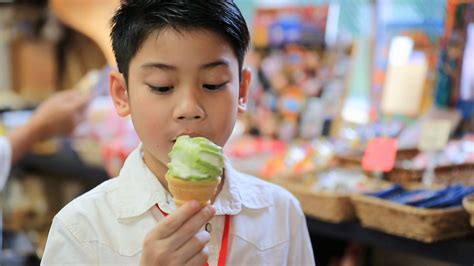 Asian Siblings Enjoying With Ice Cream Cone In T Shop Stock Video