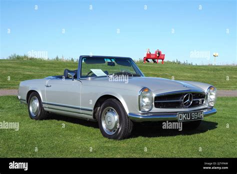 Front Side View Of A Metallic Grey Silver Mercedes Benz W113 Sl280