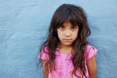 Close Up Portrait Of Innocent Little Girl Standing Against