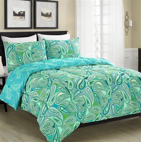 A Bed In A Room With A Blue And Green Comforter