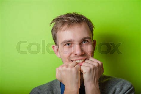 Closeup Portrait Of A Man Resting Chin On Hand Brows Raised And