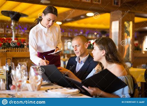Positive Young Couple Making Order At Restaurant Stock Image Image Of