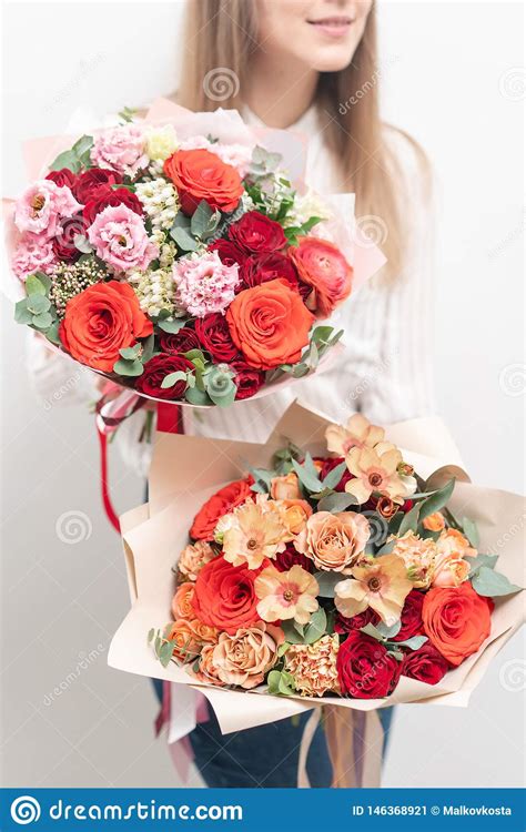 Two Beautiful Bouquets Of Mixed Flowers In Womans Hands The Work Of