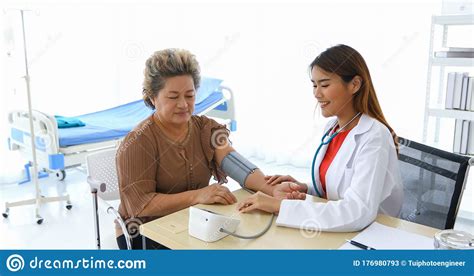 The Doctor Using Blood Pressure Gauge For Checking To Old Women
