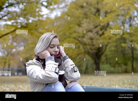 Lonely Young Woman Sitting On Bench Stock Photo Alamy
