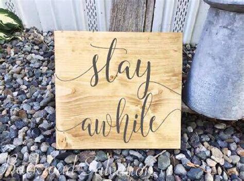 A Wooden Sign That Says Stay Awhile On It