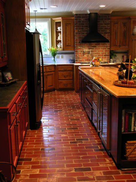 A Kitchen With Red Brick Flooring And Wooden Cabinets