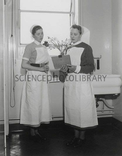 Sister And Nurse At Left Discussing A Patients Chart At St