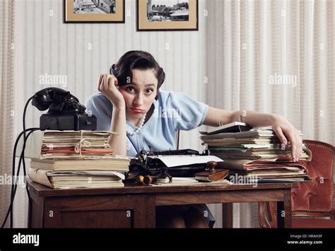 A Bored Office Worker Sitting Behind A Large Stack Of Paperwork Stock Photo Alamy