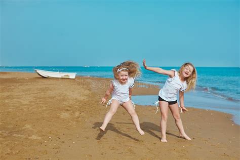 two adorable sisters plying on sea side vacation resort hotel side stock image image of beach