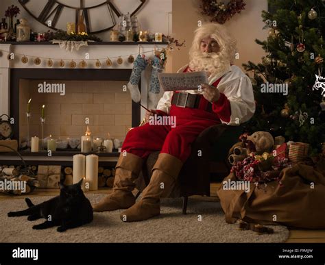 Santa Claus Resting At Home Near Christmas Tree Stock Photo Alamy