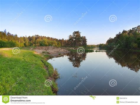 Forest Landscape With Clear Blue Sky And River Stock Photo