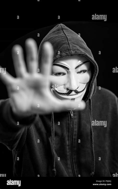 Anonymous Hacker Wearing A Guy Fawkes Mask And A Black Hoodie Stock
