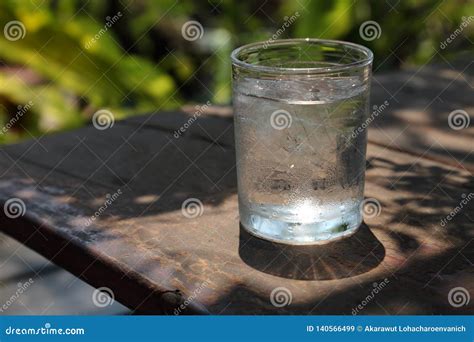Cool Glass Of Water With Droplet On Rustic Wooden Table With Strong Light Stock Image Image Of