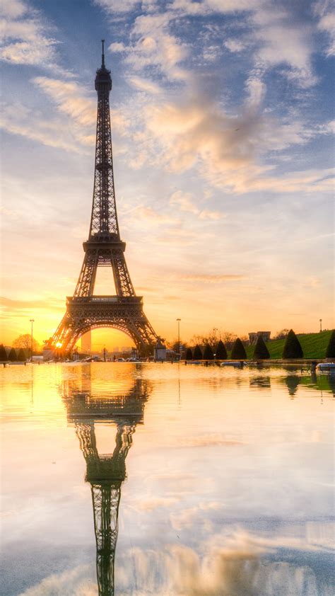 Eiffel Tower And Reflection On Water With Blue Sky And Clouds