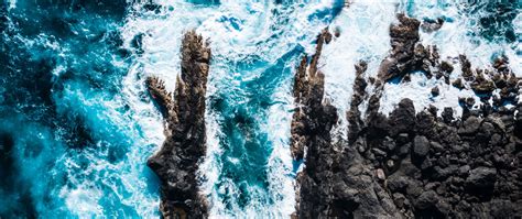 Download Wallpaper 2560x1080 Ocean Aerial View Rocks Surf Foam