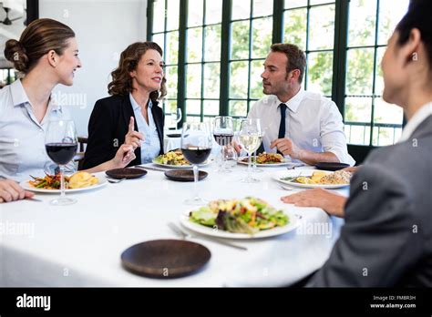 Group Of Businesspeople At Business Lunch Meeting Stock Photo Alamy