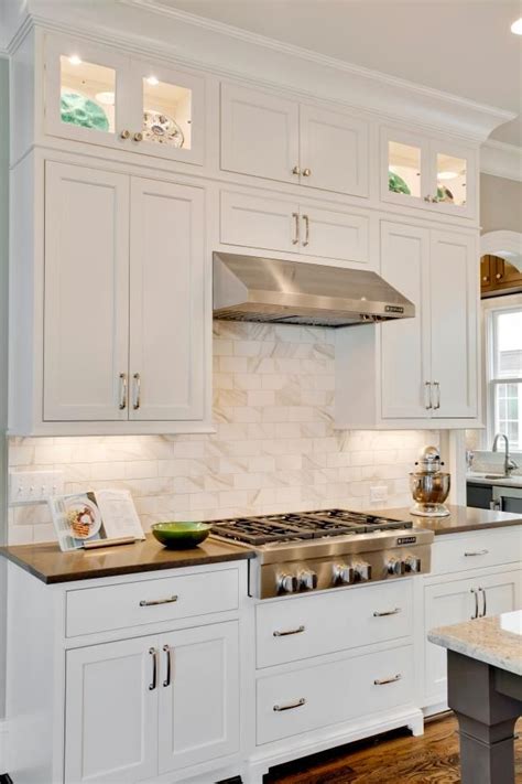 view these beautiful white shaker cabinets paired with a dreamy marble kitchen backsplash on
