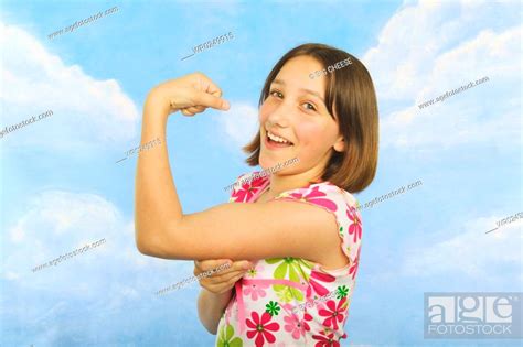 A Teenaged Girl Flexing Her Muscles Stock Photo Picture And Royalty