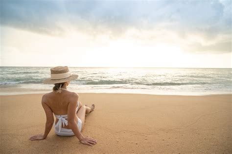 Premium Photo Back Side Of Woman In Bikini Sitting On Sand Beach