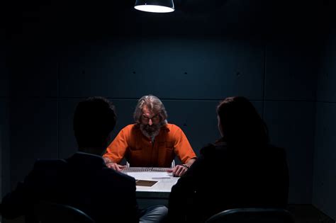 Browse Free HD Images of A Prisoner In An interrogation Room Glares At