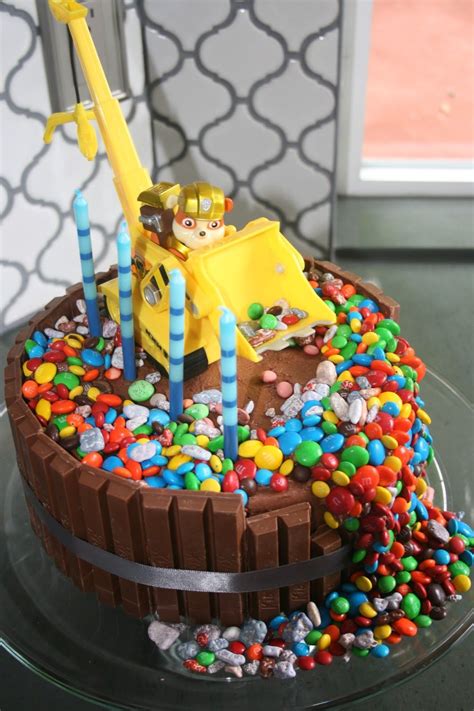 With a fondant collar featuring chase's badge, paw prints. paw patrol rubble cake! | Paw patrol birthday, Paw patrol cake