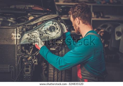 Mechanic New Car Headlight Workshop Stock Photo 324835520 Shutterstock
