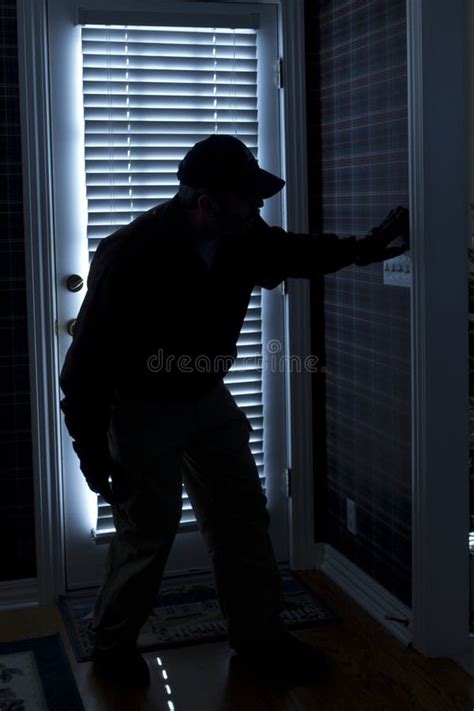 Burglar Breaking In To Home At Night Through Back Stock Photo Image