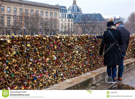 Couple Watching The Love Locks At Pont Neuf In Paris Editorial Image