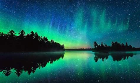 Northern Lights Aurora Borealis Over A Frozen Minnesota Lake By Dan