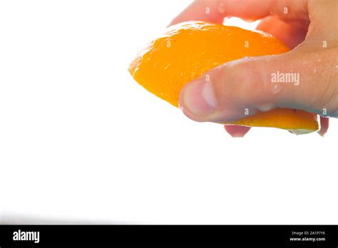 Hand Squeeze Orange Slice On White Background Stock Photo Alamy