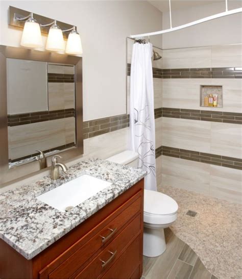 A Bathroom With Marble Counter Tops And Brown Cabinets