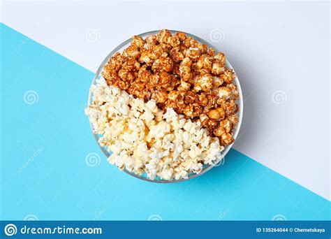 Different Kinds Of Popcorn In Bowl On Color Background
