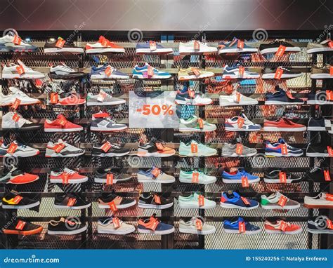 Lots Of Different Sneakers On The Showcase On Market With Tags Sale