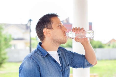 Close Up Of A Man Drinking Water From Bottle Outdoor Man Refreshing